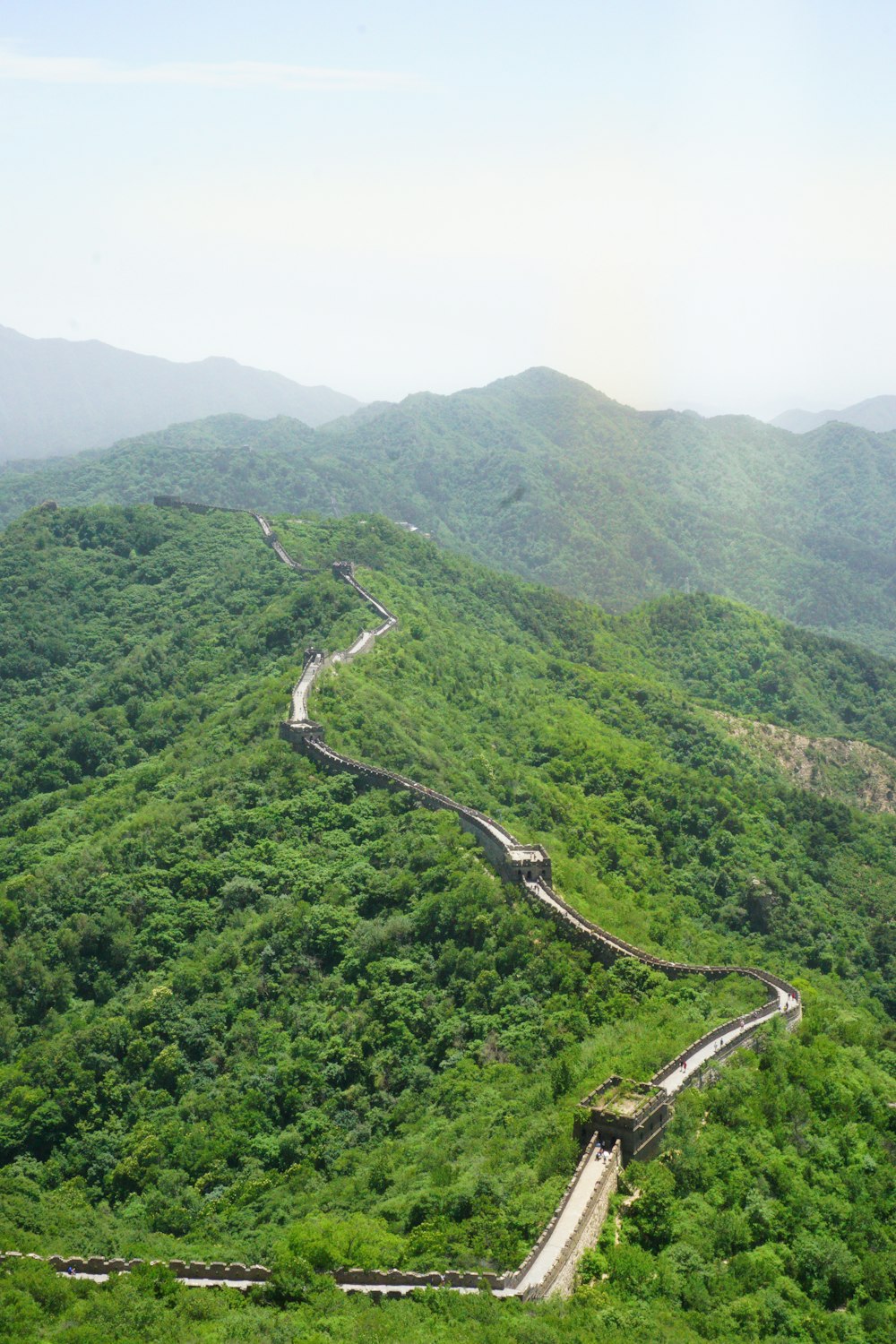 aerial view of road between green mountains during daytime