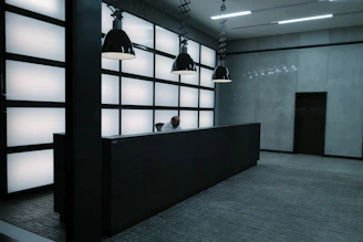 A sleek, modern office reception area with minimalist design and elegant lighting.