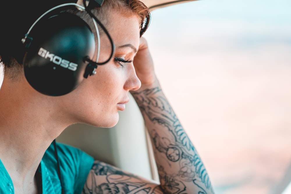 man in blue crew neck shirt wearing black headphones