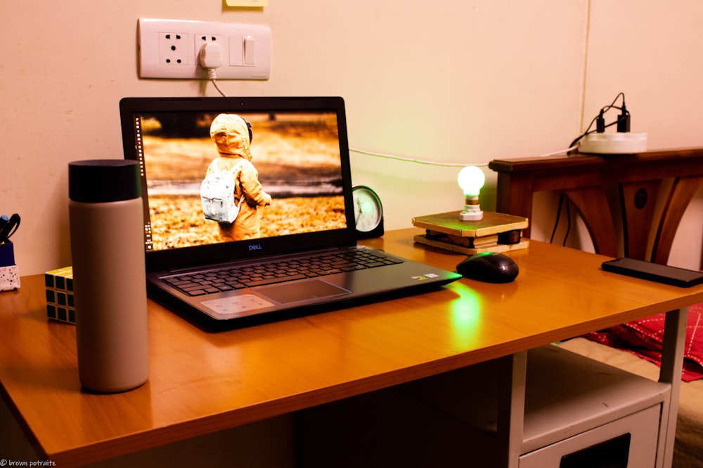 black laptop computer on brown wooden table