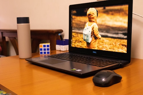 A young person happily unboxing a youthtech laptop in a cozy room.