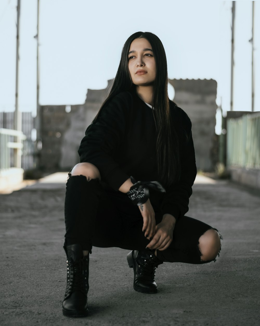 a woman sitting on the ground with her legs crossed