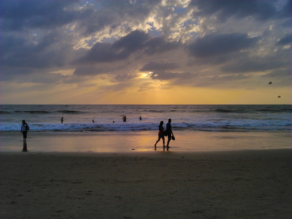 silhouette of people on beach during sunset