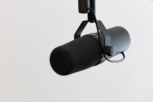 Close-up of a professional microphone mounted on a boom pole.