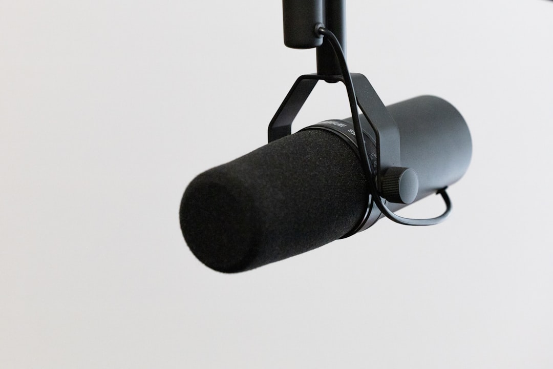 black microphone on white background, Dynamic podcasting microphone on white. Please consider crediting