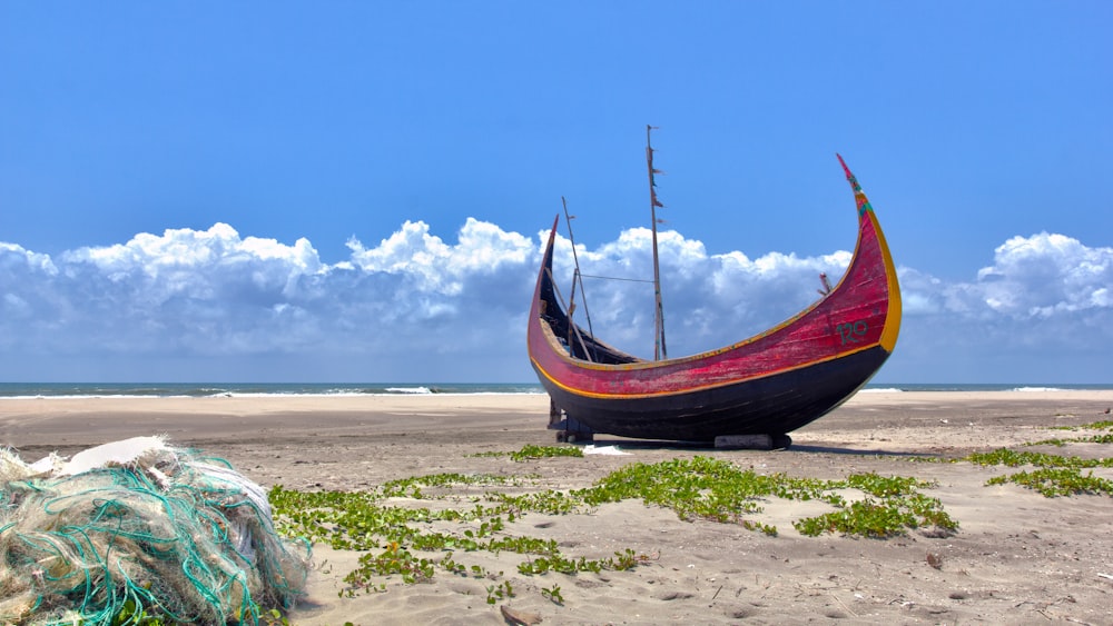 brown boat on white sand during daytime