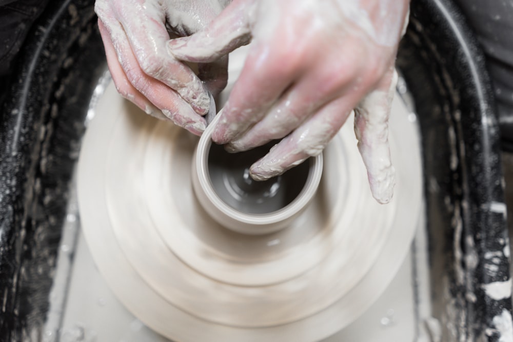 person holding round white ceramic plate