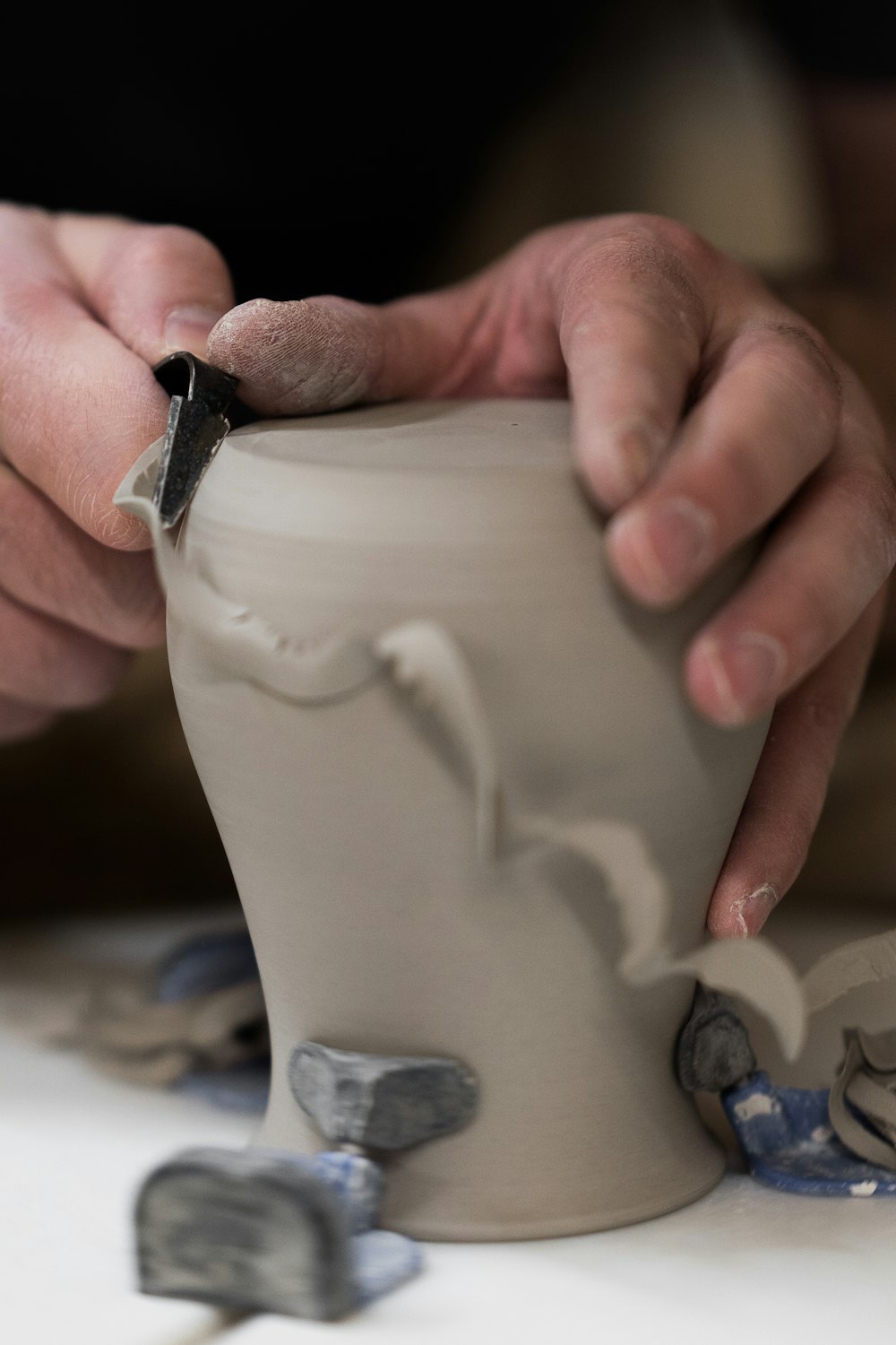 person holding white ceramic vase