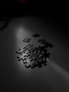 Close-up of hands arranging puzzle pieces on a bright, patterned surface