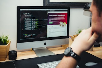 silver imac on brown wooden desk