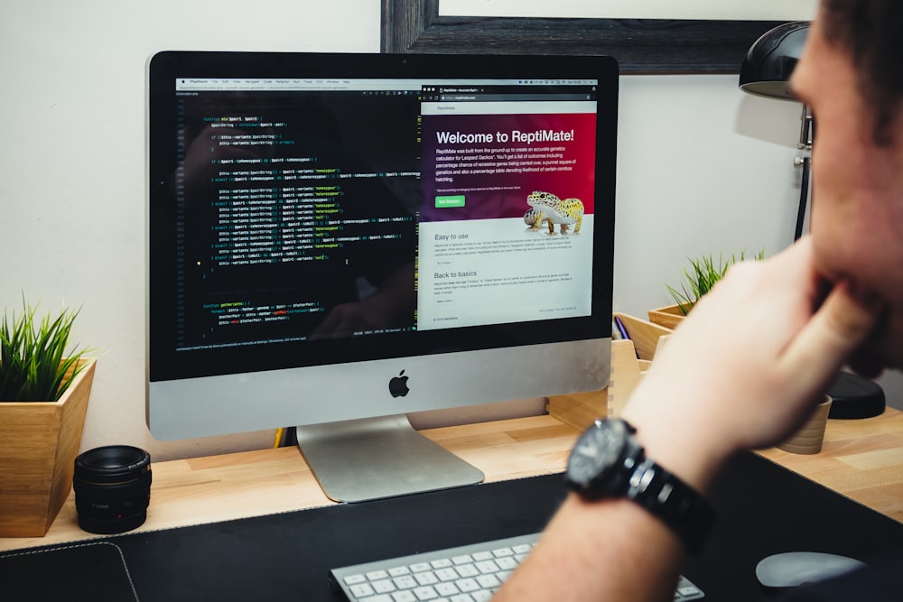 A person using a refurbished iMac in a home office.