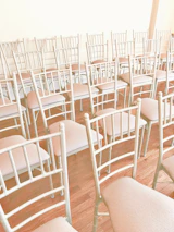 Volunteers setting up chairs for a support group meeting in a sunny community room.
