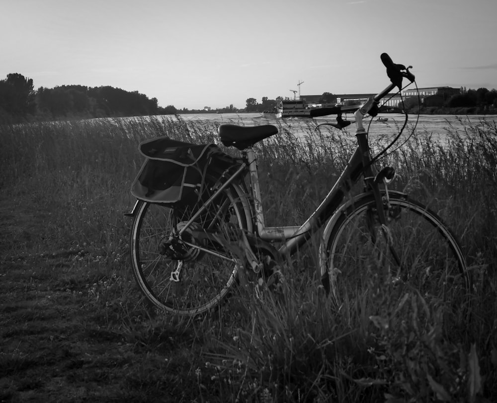 grayscale photo of city bike on grass field