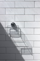 black and silver round analog watch on white ceramic wall tiles