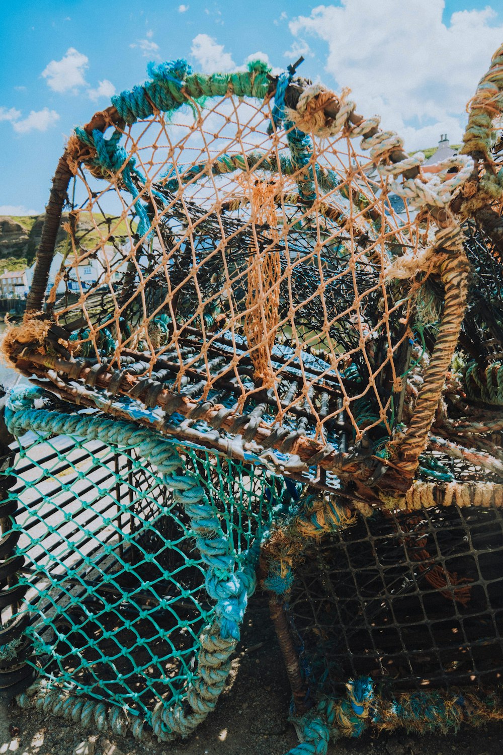 a pile of fishing nets sitting on top of a beach