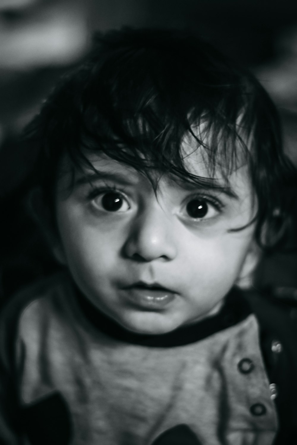 grayscale photo of child in crew neck shirt