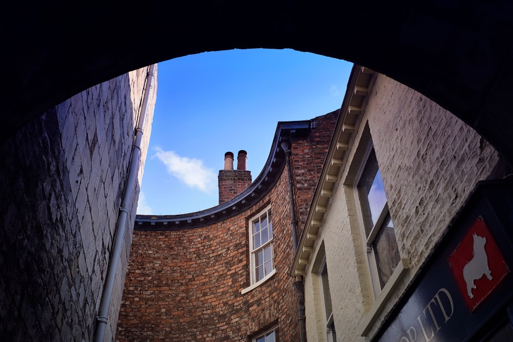 brown brick building under blue sky during daytime