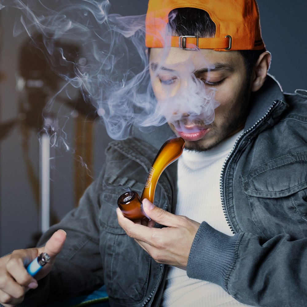 man in black leather jacket smoking cigarette