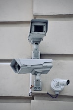 white and gray metal pipe with security cameras