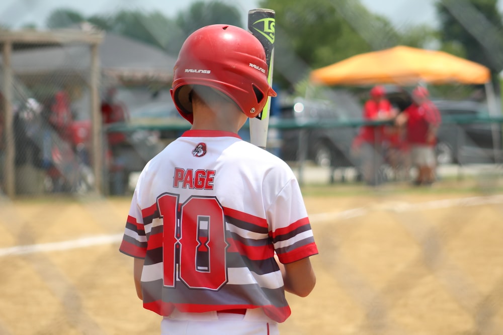 boy in white and red jersey shirt wearing red helmet