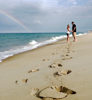 woman in black bikini walking on beach during daytime