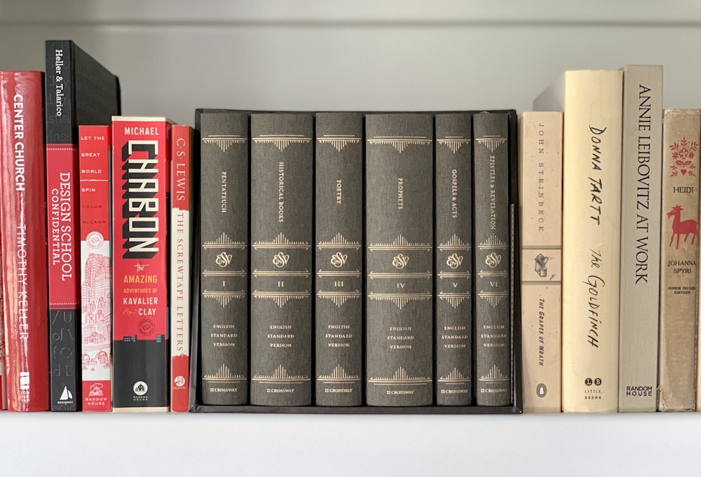 black and red books on white shelf