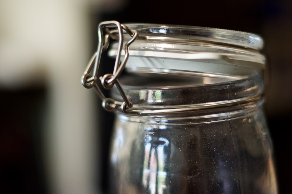 silver ring on clear glass jar