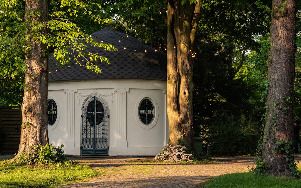 white and brown concrete house near green trees during daytime