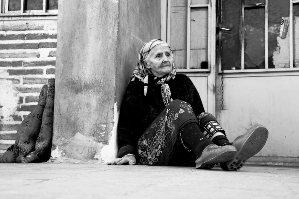 woman in black and white floral dress sitting on floor