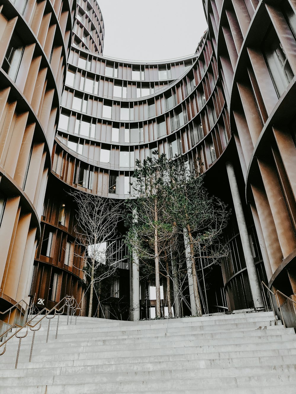 brown concrete building with green trees