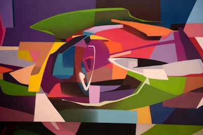 An abstract artwork featuring an array of geometric shapes interwoven in a dynamic composition. The painting includes a vibrant mix of colors and forms that suggest movement and depth, with curved and angular shapes overlapping and interacting.