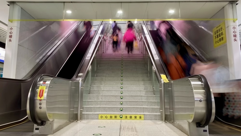 woman in purple jacket walking on gray staircase