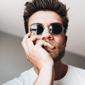 man in white crew neck shirt wearing black sunglasses