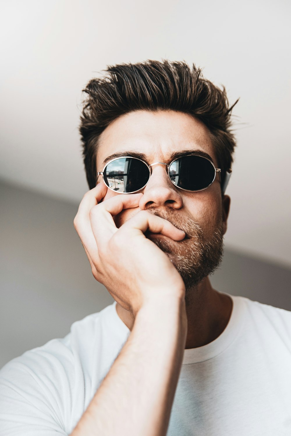 man in white crew neck shirt wearing black sunglasses