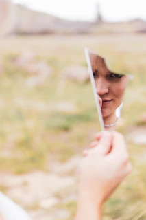 a woman looking at herself in the mirror