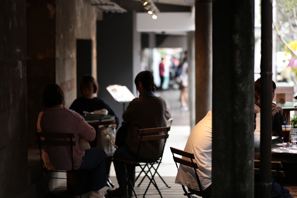 people sitting on chair in restaurant during daytime