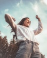 woman in white long sleeve shirt and blue denim jeans