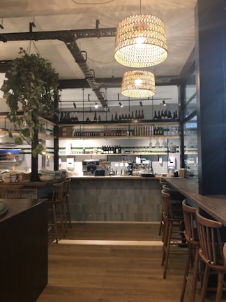 Sleek pendant lights hanging over a stylish hotel bar.