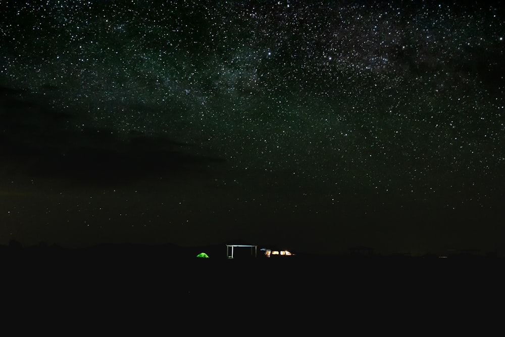 silhouette of buildings under starry night