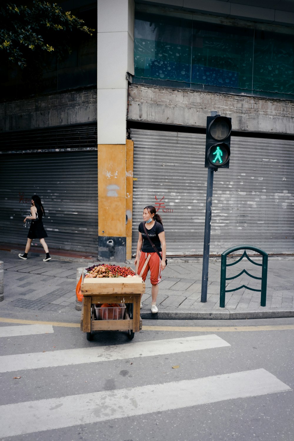 man in black t-shirt and blue denim jeans carrying brown wooden box with orange plastic