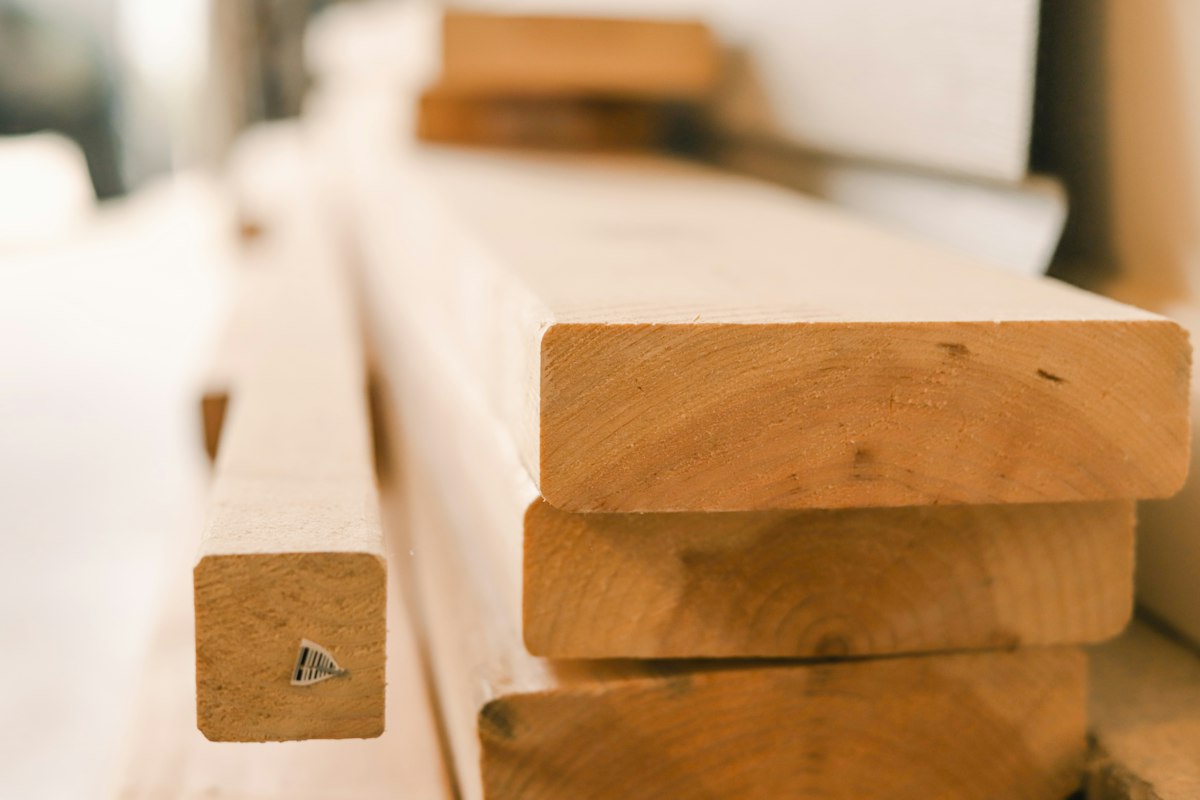 Planed hardwood boards stacked in a wood factory in Vietnam, ready for machining