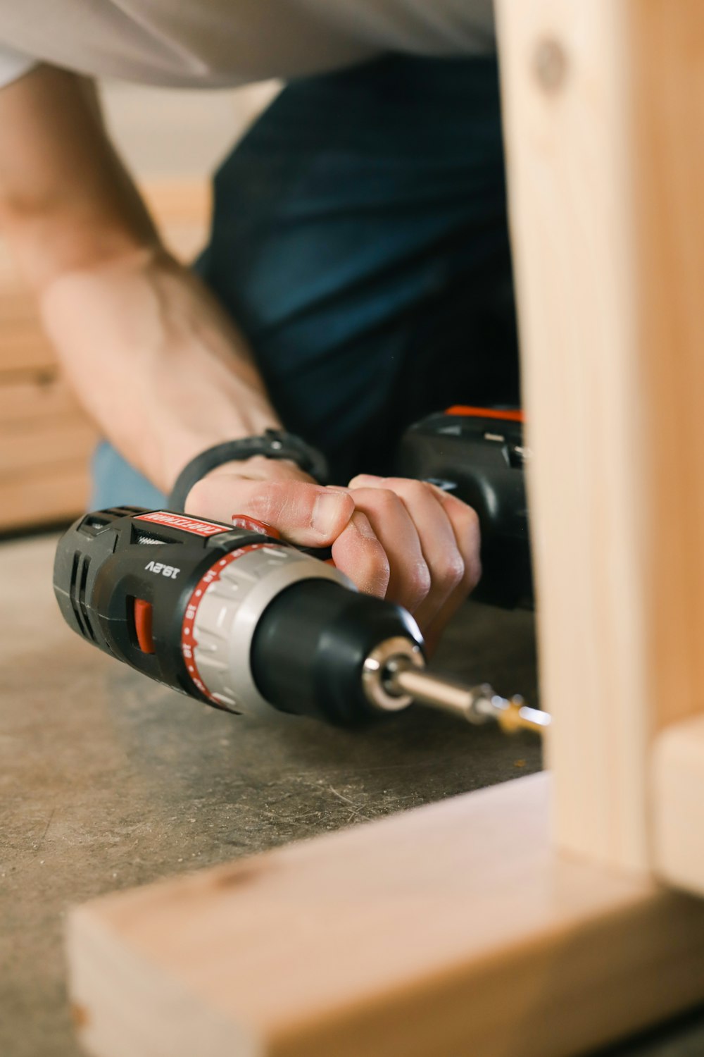 person holding black and red cordless hand drill