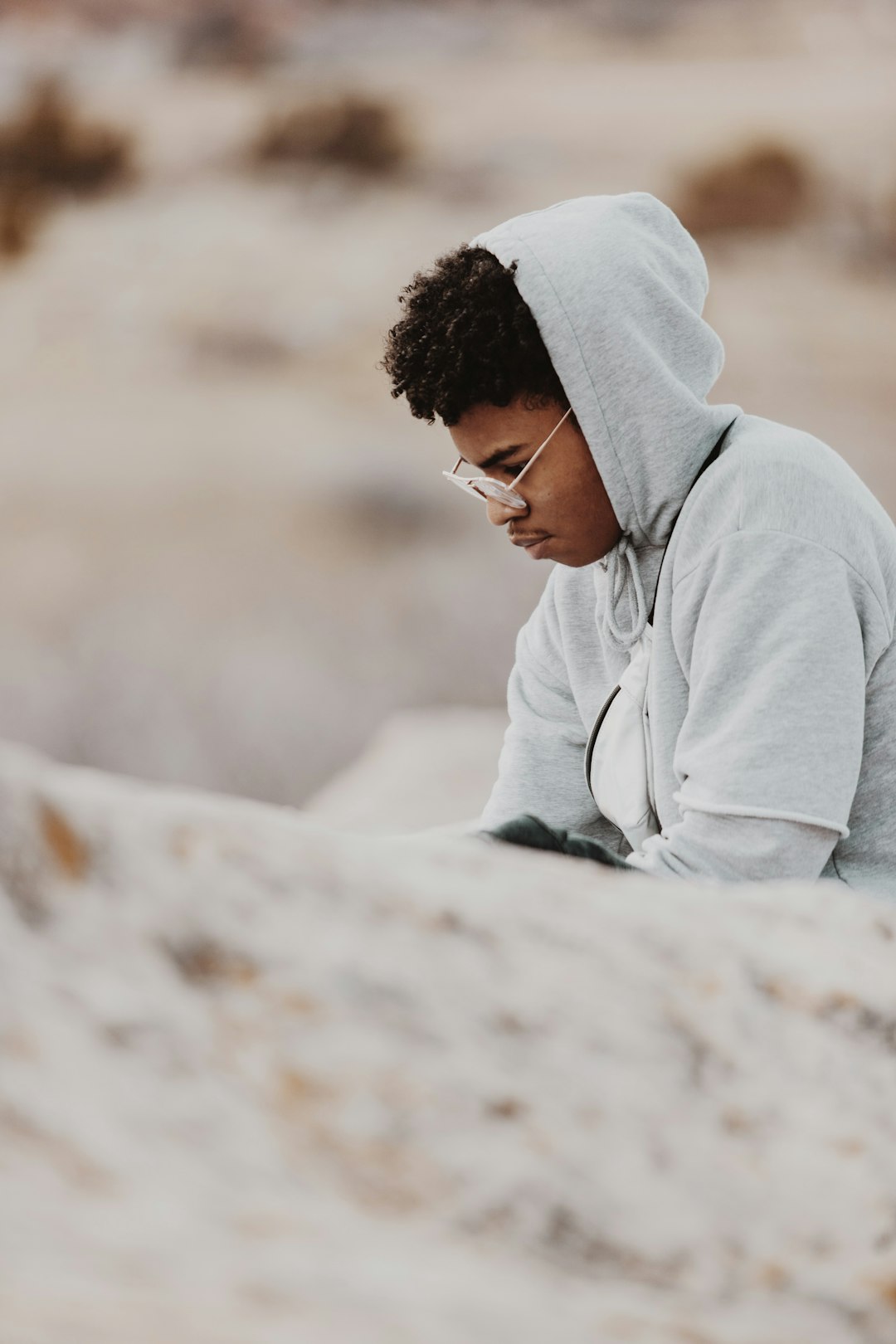 man in gray hoodie looking down