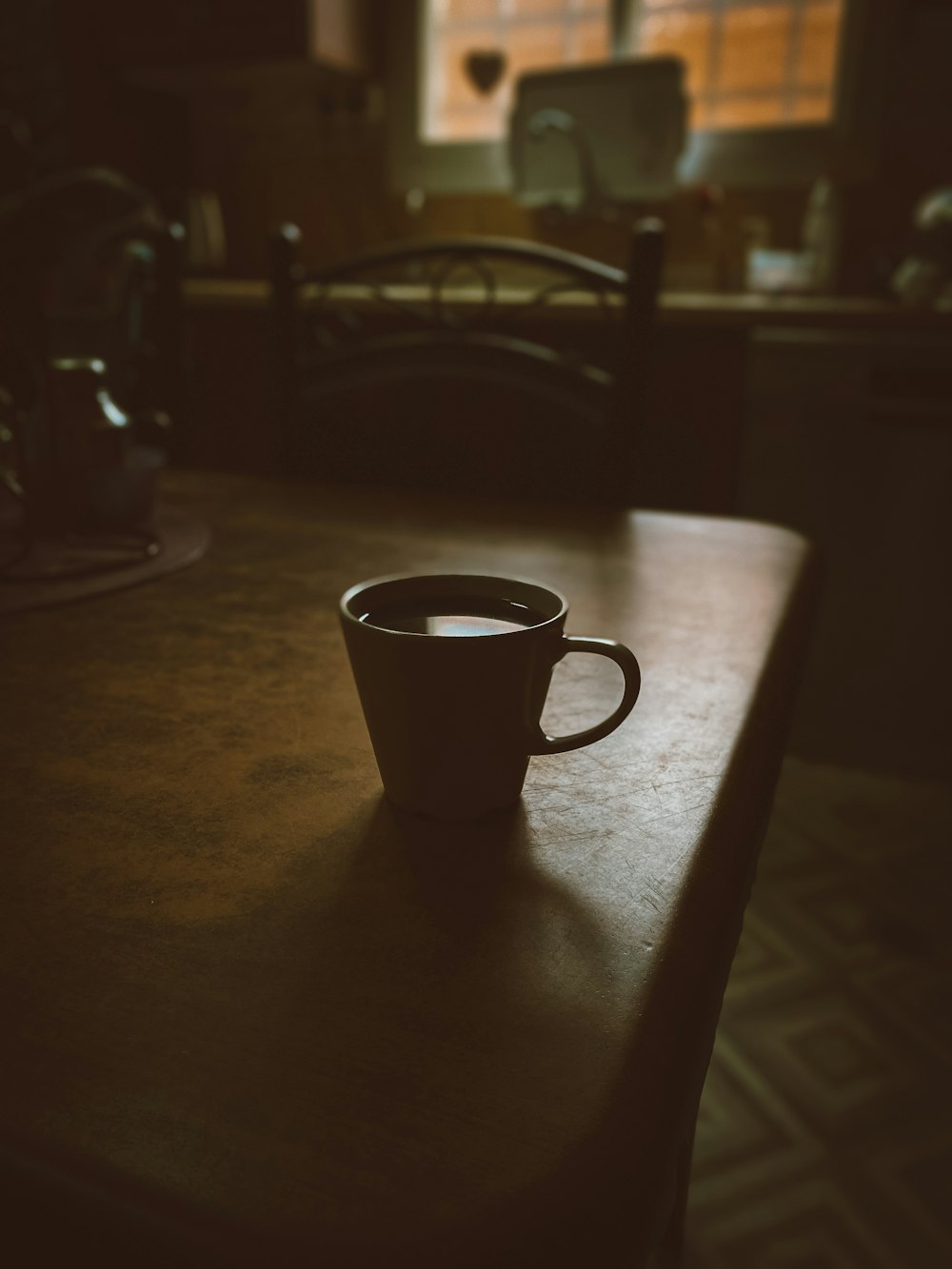 black ceramic mug on brown wooden table