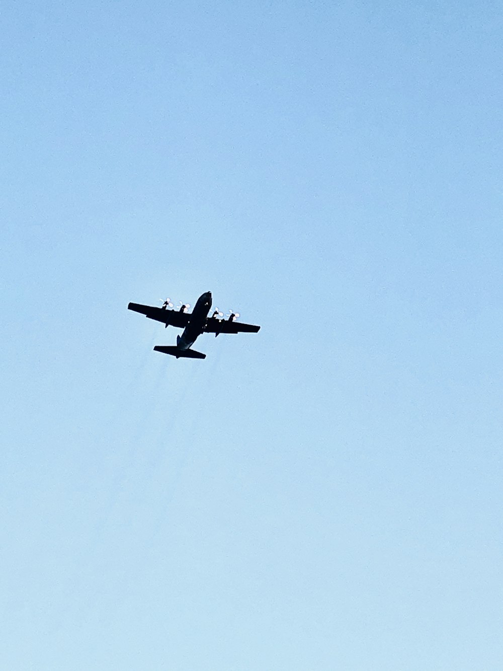 black airplane in mid air during daytime