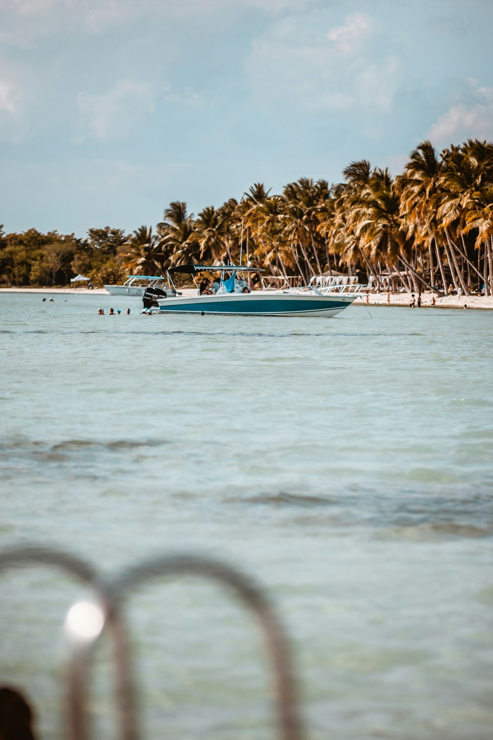 white and blue boat on sea during daytime