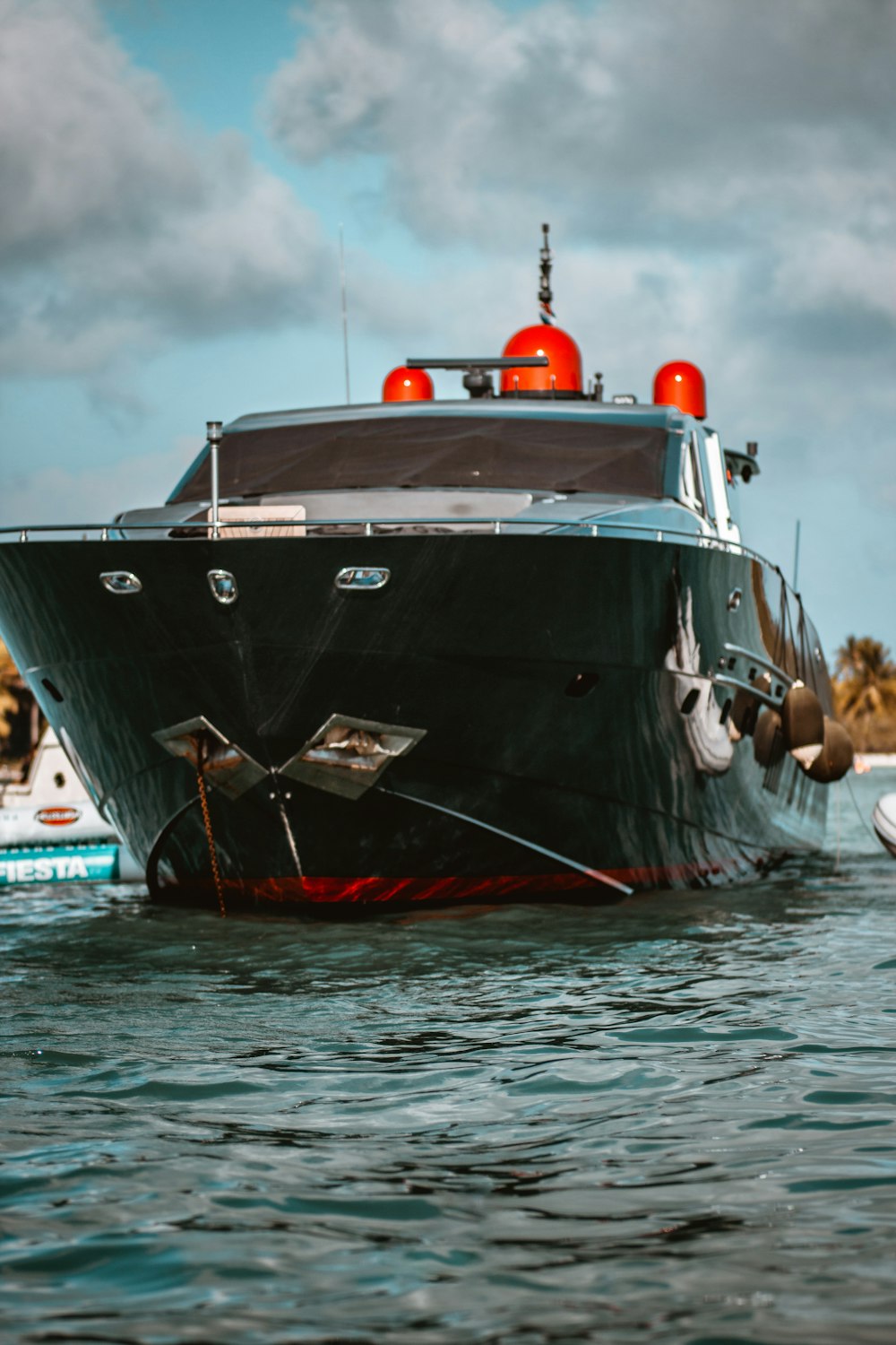 black and red boat on body of water during daytime