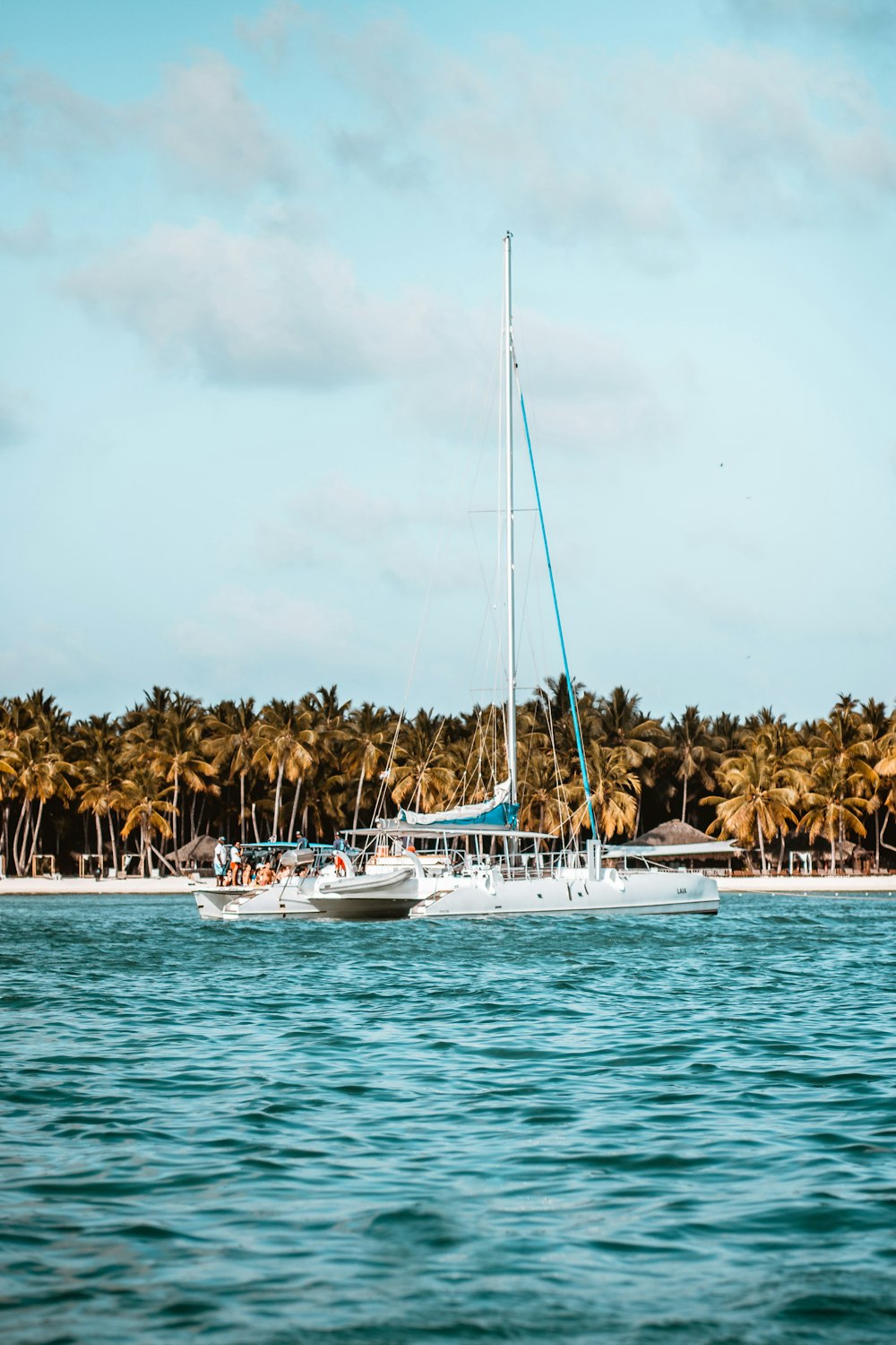 white boat on sea under cloudy sky during daytime