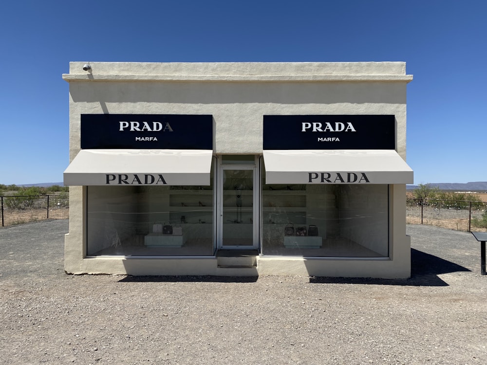 a building with two doors and a sign that says prada