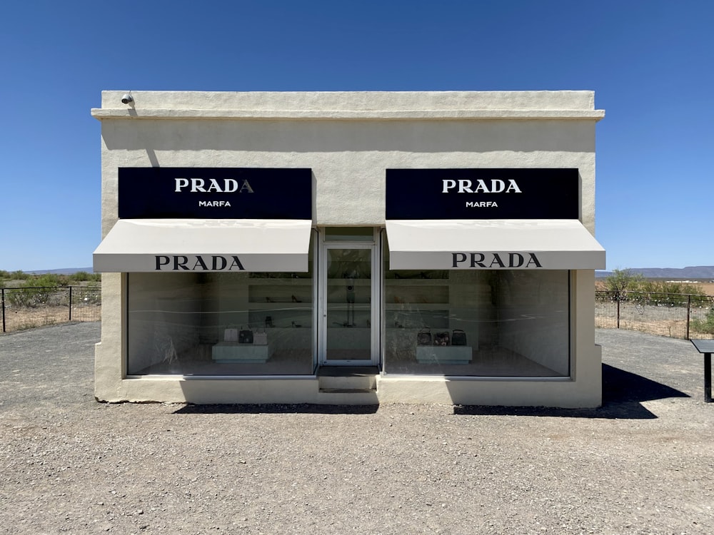 a building with two doors and a sign that says prada